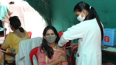 A health worker administers a dose of Covid vaccine to a beneficiary at the district hospital in Kullu, HP, on Friday. (Aqil Khan/Hindustan Times) A health worker administers a dose of Covid vaccine to a beneficiary at the district hospital in Kullu, HP, on Friday. (Aqil Khan/Hindustan Times)