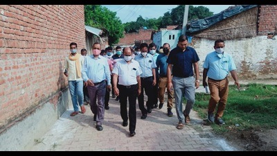 Kheri DM Arvind Kumar Chaurasiya inspecting Kaima Bujurg village in Kheri on Friday. (ht photo)