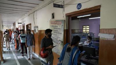 People stand in a queue to get themselves registered for taking the Covid-19 vaccine at a healthcare facility in New Delhi on August 24, 2021. (AP) People stand in a queue to get themselves registered for taking the Covid-19 vaccine at a healthcare facility in New Delhi on August 24, 2021. (AP)