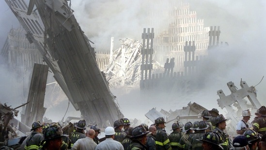 A group of firefighters stand on the street near the destroyed World Trade Centre in New York on September 11, 2001. Stapleton, then a freelancer for Reuters, took a few frames of a group of people emerging from what remained of the building's lobby.(Shannon Stapleton / REUTERS)