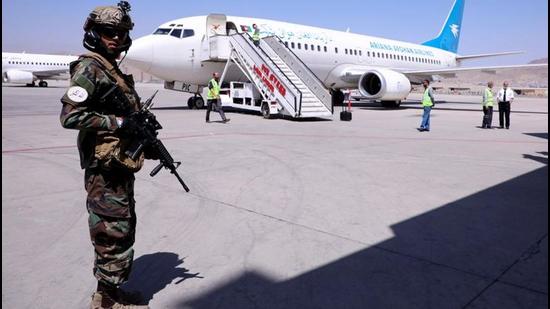 A member of Taliban forces stands guard next to a plane at Hamid Karzai International Airport in Kabul. America’s credibility might have been stonewashed in Afghanistan, but there is little reassurance needed to those nations committed to areas of interests well inside Biden’s geopolitical wheelhouse. These interests include managing China, investing in Quadrilateral alliances, and doubling down on new marketplaces and opportunities in the Indo-Pacific. (REUTERS)