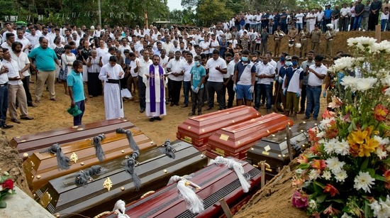 A priest conducts religious rituals during a mass burial for Easter Sunday bomb blast victims in Negombo, Sri Lanka. (AP Photo) A priest conducts religious rituals during a mass burial for Easter Sunday bomb blast victims in Negombo, Sri Lanka. (AP Photo)