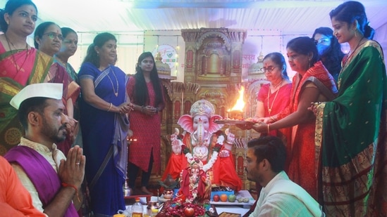 Devotees worship a Ganesh idol at a puja pandal on Ganesh Chaturthi festival, in Gurugram on September 10.(PTI)