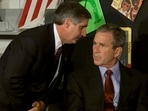 US President George W. Bush listens as White House Chief of Staff Andrew Card informs him of a second plane hitting the World Trade Center.