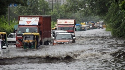 Commuters move through a wheel deep waterlogged road amid rainfall, at ITO, in New Delhi on Saturday. (ANI)