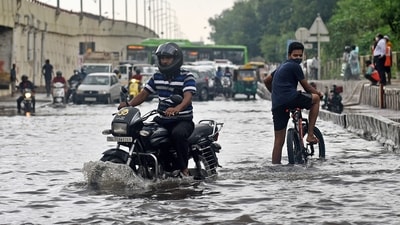  A biker struggles to cross a waterlogged road after heavy rainfall at NH-24 near Vinod Nagar, in New Delhi on Saturday. (ANI Photo) A biker struggles to cross a waterlogged road after heavy rainfall at NH-24 near Vinod Nagar, in New Delhi on Saturday. (ANI Photo)