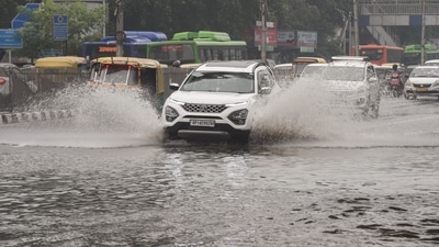 Traffic is seen in a waterlogged area following heavy rain in New Delhi, (PTI Photo) Traffic is seen in a waterlogged area following heavy rain in New Delhi, (PTI Photo)