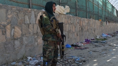 A Taliban fighter stands guard at the site of the attacks, in Kabul airport on August 27. (AFP) A Taliban fighter stands guard at the site of the attacks, in Kabul airport on August 27. (AFP)