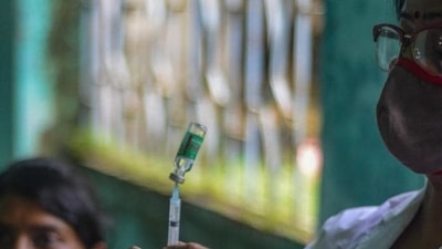 A health worker prepares a dose of Covishield vaccine against the Covid-19 at a vaccination camp in Siliguri. (AFP file photo) A health worker prepares a dose of Covishield vaccine against the Covid-19 at a vaccination camp in Siliguri. (AFP file photo)