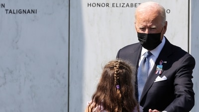 US President Joe Biden reaches out a hand to a girl in the crowd during a visit to the wall of the names of the victims on the 20th anniversary of the 9/11 attacks at the Flight 93 National Memorial in Stoystown, Pennsylvania. (REUTERS/Hannah Beier)