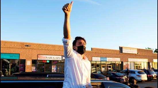 Canada’s Prime Minister Justin Trudeau waves to supporters during his election campaign tour in Whitby, Ontario, on Friday. An unidentified man has been arrested and charged by police in the province of Ontario for threatening Justin Trudeau while he was campaigning in the town of Cambridge in late August. (REUTERS)