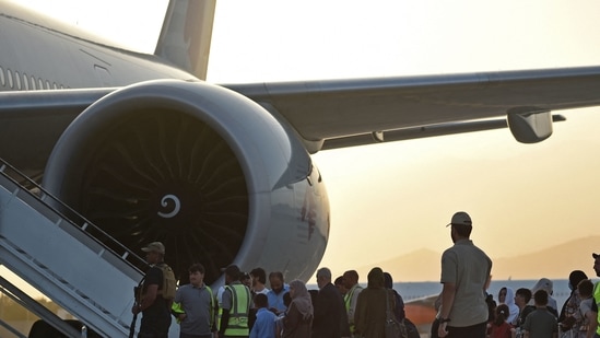 Passengers prepare to board a Qatar Airways aircraft at the airport in Kabul on September 9, 2021.