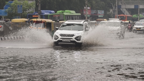 Traffic is seen in a waterlogged area following heavy rain in New Delhi, (PTI Photo) Traffic is seen in a waterlogged area following heavy rain in New Delhi, (PTI Photo)