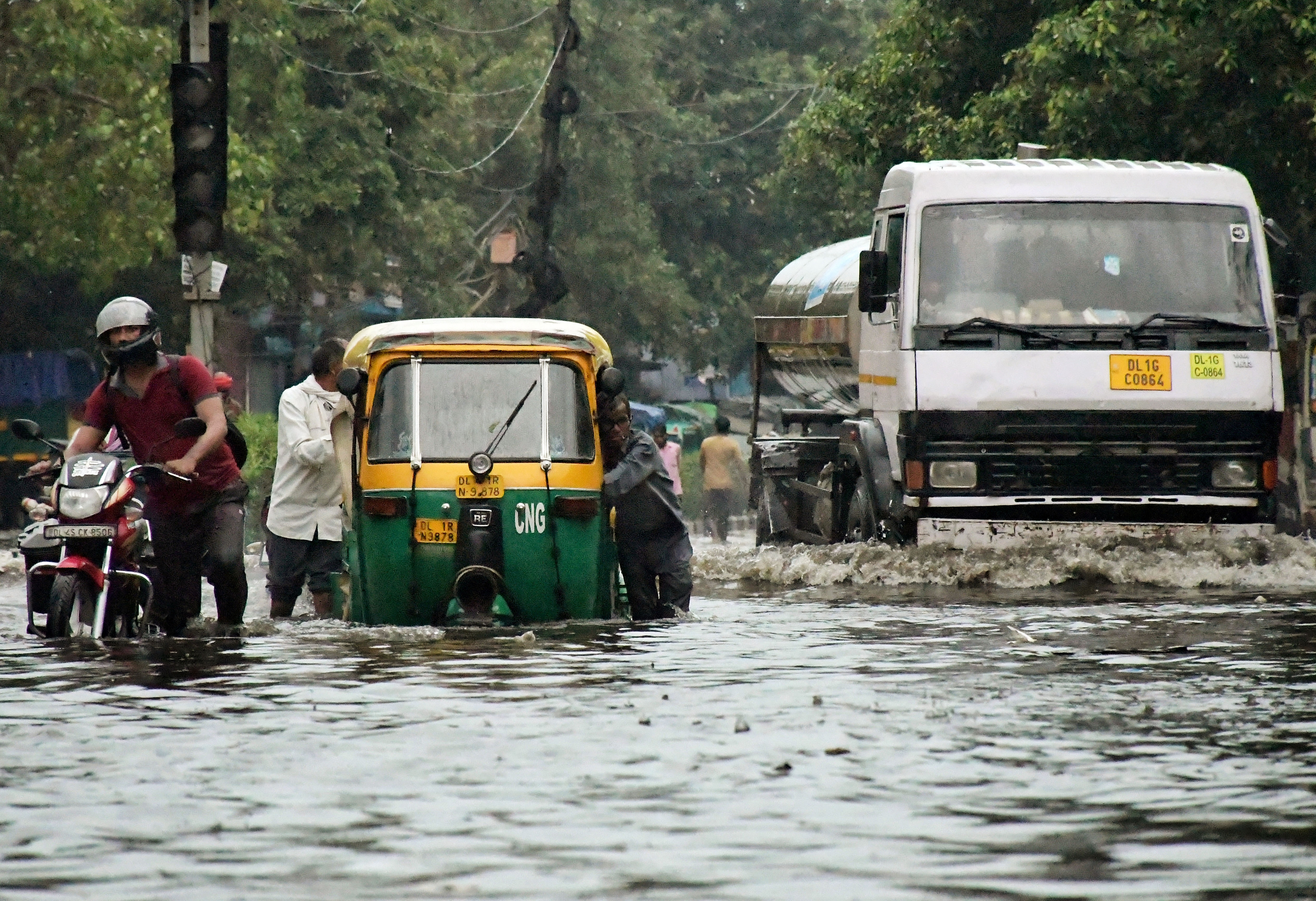 Vehicles wade through a waterlogged road following heavy rainfall, at Anand Parbat in New Delhi on Saturday. (ANI Photo) Vehicles wade through a waterlogged road following heavy rainfall, at Anand Parbat in New Delhi on Saturday. (ANI Photo)