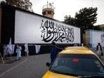 The iconic Taliban flag is painted on a wall outside the American embassy compound in Kabul on 9/11. The iconic Taliban flag is painted on a wall outside the American embassy compound in Kabul on 9/11. 