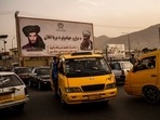 Vehicles drive past a mural paying homage to late Taliban founder Mullah Mohammad Omar, left, and the late founder of the feared Haqqani network, Jalaluddin Haqqani, in Kabul. Vehicles drive past a mural paying homage to late Taliban founder Mullah Mohammad Omar, left, and the late founder of the feared Haqqani network, Jalaluddin Haqqani, in Kabul.