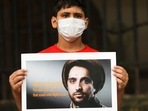 An Afghan boy holds up a sign with the image of Ahmad Massoud as he takes part in a protest against Pakistan in New Delhi.&nbsp;