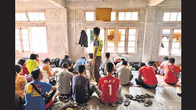 Myanmarese policemen, who fled Myanmar and crossed illegally to India, sit in a temporary shelter at an undisclosed location in Mizoram on March 13, 2021. (AFP) Myanmarese policemen, who fled Myanmar and crossed illegally to India, sit in a temporary shelter at an undisclosed location in Mizoram on March 13, 2021. (AFP)