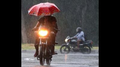 Bikers making their way through rain in Sector 33, Chandigarh, on Sunday. (KESHAV SINGH/HT)