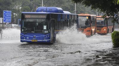 DTC buses pass through a waterlogged road at ITO after heavy rain in New Delhi on Saturday (Arvind Yadav/HT PHOTO) DTC buses pass through a waterlogged road at ITO after heavy rain in New Delhi on Saturday (Arvind Yadav/HT PHOTO)