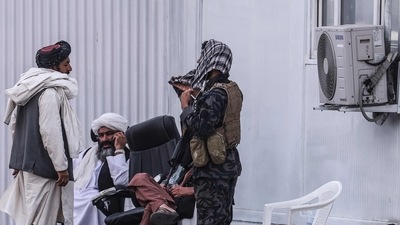 Members of the Taliban sit at a checkpoint near the airport in Kabul on September 12, 2021.&nbsp; (AFP)