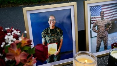 Photos of US Marine Corps sergeant Johanny Rosario Pichardo are seen at a makeshift memorial for the 13 US troops killed in Afghanistan.&nbsp; (File Photo / REUTERS)