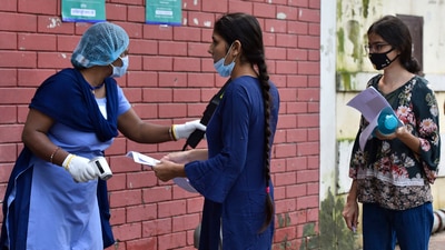 A security personnel screens a NEET aspirant before entering the exam centre, at Kerala School, in New Delhi on September 12. (HT Photo/Sanjeev Verma) A security personnel screens a NEET aspirant before entering the exam centre, at Kerala School, in New Delhi on September 12. (HT Photo/Sanjeev Verma)