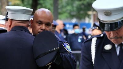 Members of the 9/11 Honor Guard embrace at the end of their duty at the conclusion of the commemoration ceremony at the at the National 9/11 Memorial New York City. (AFP) Members of the 9/11 Honor Guard embrace at the end of their duty at the conclusion of the commemoration ceremony at the at the National 9/11 Memorial New York City. (AFP)