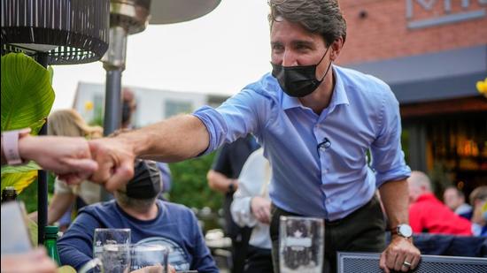 Canada's Prime Minister Justin Trudeau greets supporters during his election campaign tour in Saint Bruno-de-Montarville in Canada on September 11, 2021. He has been campaigning for the September 20 Canada elections. (REUTERS)