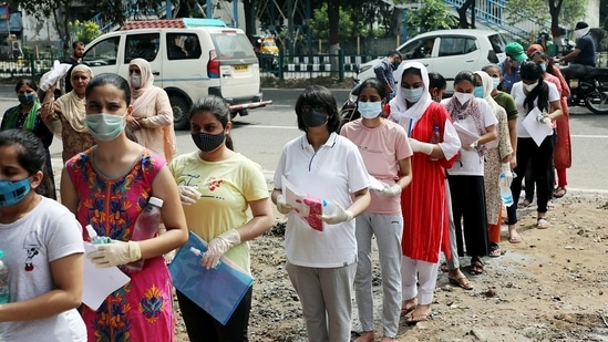 Strict adherence to Covid-19 measures was taken by the students and the school authorities. as students arrived to appear for NEET exam 2021.(ANI)