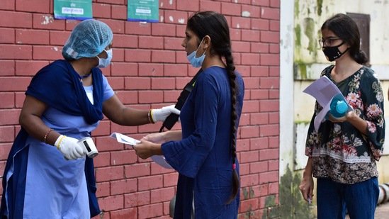 A security personnel screens a NEET aspirant before entering the exam centre, at Kerala School, in New Delhi on September 12.(HT Photo/Sanjeev Verma)