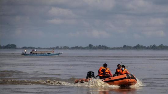 National Disaster Response Force personnel search for missing people after two passenger ferries collided Wednesday in the river Brahmaputra, near Nimati Ghat in Jorhat on September 9. (AP)
