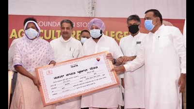 Punjab chief minister Captain Amarinder Singh handing over a loan waiver certificate to a farmer in SBS Nagar on Monday. (HT photo)
