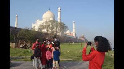 A family posing in front of Taj Mahal in Agra. The commissioner of Agra division, Amit Gupta visited the Taj and while viewing the monument he was disturbed after finding mobile towers in the background view. (HT FILE PHOTO) A family posing in front of Taj Mahal in Agra. The commissioner of Agra division, Amit Gupta visited the Taj and while viewing the monument he was disturbed after finding mobile towers in the background view. (HT FILE PHOTO)