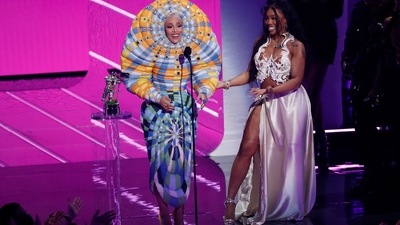 Doja Cat accepted the Best Collaboration award for Kiss Me More with SZA looking rather quirky. She wore a psychedelic yellow-and-blue tiered Thom Browne dress from the designer's Spring 2018 collection, and undoubtedly became the talk of the internet.&nbsp; (REUTERS)