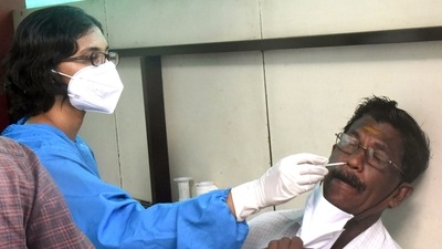 A Kerala healthcare worker takes a nasal sample from a man for the Covid-19 test at the Government General Hospital in Kochi.&nbsp; (ANI File Photo)