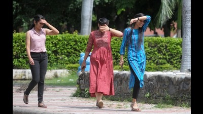 Girls trying to protect themselves from the scorching heat at Panjab University, Chandigarh, on Monday. The maximum temperature was recorded at 34.5°C, one degree above normal. (Ravi Kumar/HT)