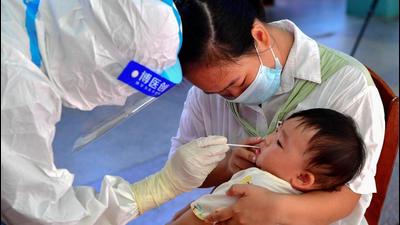 A child undergoes a nucleic acid test for Covid-19 in Xianyou county, Putian city, in China’s eastern Fujian province on Monday. A Chinese national who completed 28 days in quarantine including three weeks at a centralised isolation has been identified as the likely source of the new outbreak spreading in Fujian. (AFP) A child undergoes a nucleic acid test for Covid-19 in Xianyou county, Putian city, in China’s eastern Fujian province on Monday. A Chinese national who completed 28 days in quarantine including three weeks at a centralised isolation has been identified as the likely source of the new outbreak spreading in Fujian. (AFP)