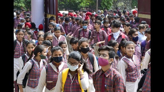 Social distancing and mask norms being flouted as students enter the examination centre at Government School, PAU, in Ludhiana on Monday. (Harsimar Pal SIngh/HT)