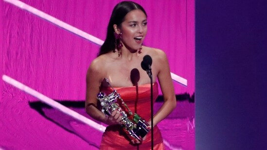 Olivia Rodrigo wins Best New Artist at the 2021 MTV VMAs.  She chose an archival look from Versace for her big day, showing off draped details in a strapless flounce gown in various shades of pink.  (REUTERS)