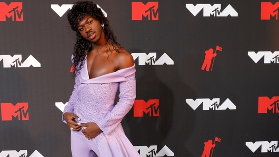 For his red carpet appearance, American rapper and singer-songwriter Lil Nas X wore a bedazzling lavender custom made suit from Versace with a floor-sweeping cape.(REUTERS)