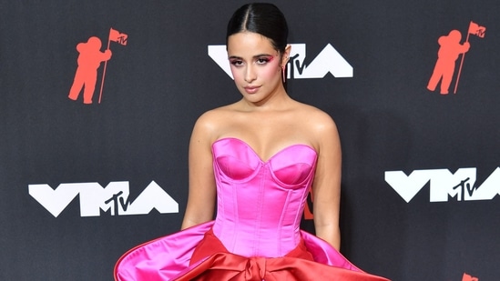 US-Cuban singer-songwriter Camila Cabello had a glamorous red carpet moment at the MTV VMAs in a pink and red couture gown with a bow embellishment by Alexis Mabille. She teamed it with Giuseppe Zanotti heels.(AFP)