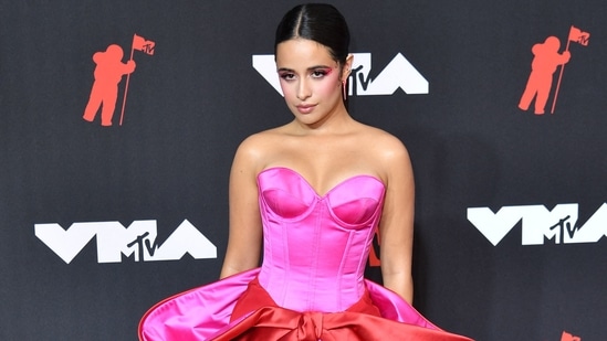 Photos: All the biggest moments from the 2021 MTV Video Music Awards US-Cuban singer-songwriter Camila Cabello had a glamorous red carpet moment at the MTV VMAs in a pink and red couture gown with a bow embellishment by Alexis Mabille. She teamed it with Giuseppe Zanotti heels.(AFP)