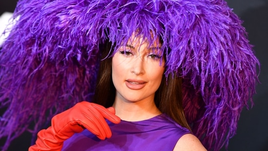 US singer-songwriter Kacey Musgraves arrived at the 2021 MTV Video Music Awards at Barclays Centre and how! She chose to head-turning Valentino couture look and made head turn. She wore a fabulous feathered hat with a silk party dress and red leather opera gloves.(AFP)