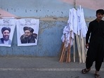 A vendor selling Taliban flags stand next to the posters of Taliban leaders Mullah Abdul Ghani Baradar and Amir Khan Muttaqi (L) as he waits for customers along a street in Kabul, following the Taliban's military takeover of Afghanistan. A vendor selling Taliban flags stand next to the posters of Taliban leaders Mullah Abdul Ghani Baradar and Amir Khan Muttaqi (L) as he waits for customers along a street in Kabul, following the Taliban's military takeover of Afghanistan. 