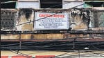 A notice put up by North Delhi Municipal Corporation on a building in Sabzi Mandi area, declaring it dangerous. A four-storey building in the area, near Robin Cinema, collapsed on Monday killing two children. (HT Photo)