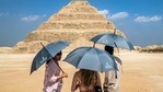 Visitors stand with umbrellas near the step pyramid of the third dynasty Ancient Egyptian Pharaoh Djoser (27th century BC) at the Saqqara Necropolis south of Egypt's capital Cairo.(AFP) Visitors stand with umbrellas near the step pyramid of the third dynasty Ancient Egyptian Pharaoh Djoser (27th century BC) at the Saqqara Necropolis south of Egypt's capital Cairo.(AFP)