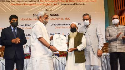 J&K L-G Manoj Sinha hands over the Forest Rights statutory document to a tribal beneficiary during a ceremony in Srinagar on Monday, Sept 13. (PTI) J&K L-G Manoj Sinha hands over the Forest Rights statutory document to a tribal beneficiary during a ceremony in Srinagar on Monday, Sept 13. (PTI)