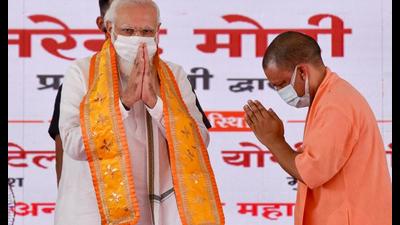Uttar Pradesh chief minister Yogi Adityanath greets Prime Minister Narendra Modi during the foundation stone laying ceremony of Raja Mahendra Pratap Singh University, in Aligarh on Tuesday, (ANI Photo)