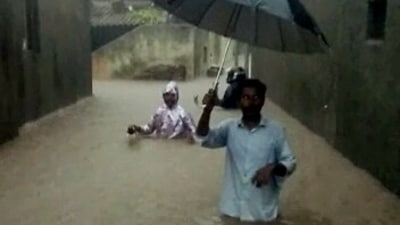 People wade through waterlogged street following heavy rainfall, in Rajkot on September 13. (ANI) People wade through waterlogged street following heavy rainfall, in Rajkot on September 13. (ANI)